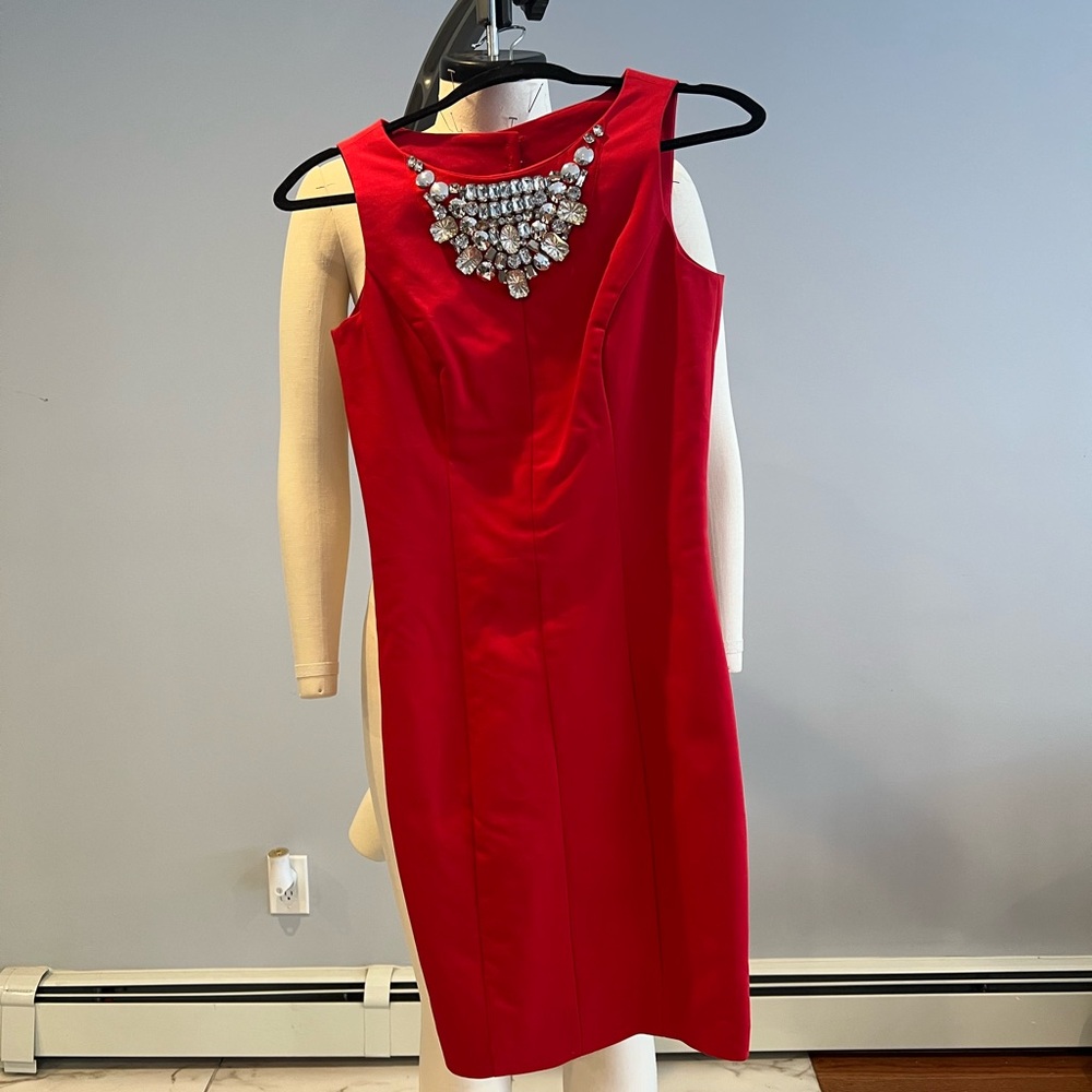Elegant Red Sleeveless Dress with Statement Necklace